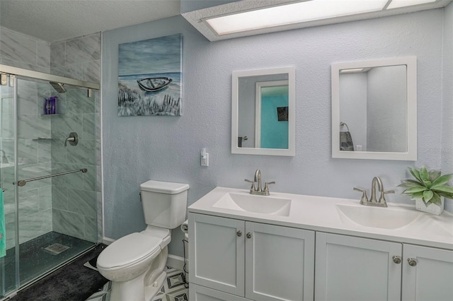 bathroom featuring a textured ceiling, vanity, toilet, and walk in shower