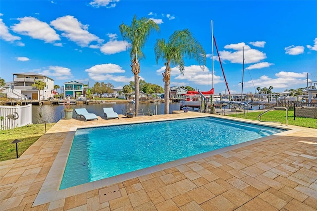 view of pool with a patio area and a water view