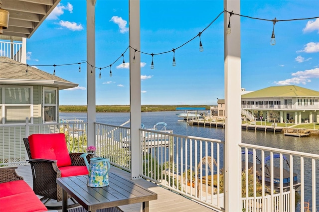 wooden deck featuring a water view