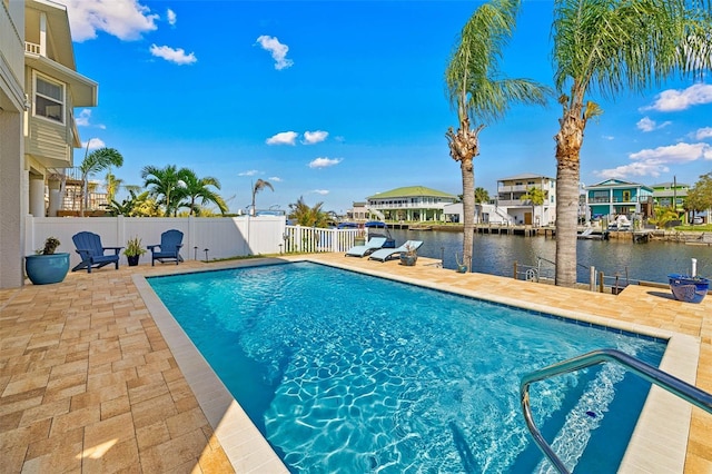 view of pool with a water view and a patio area