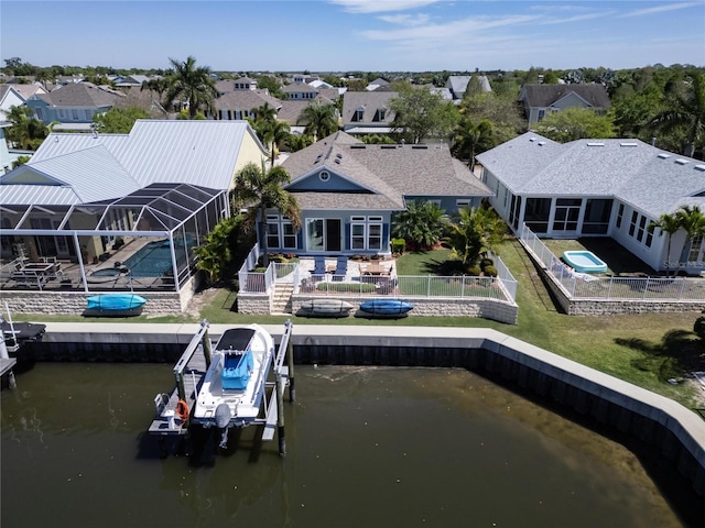 exterior space with a patio area, a pool, a lanai, and a water view