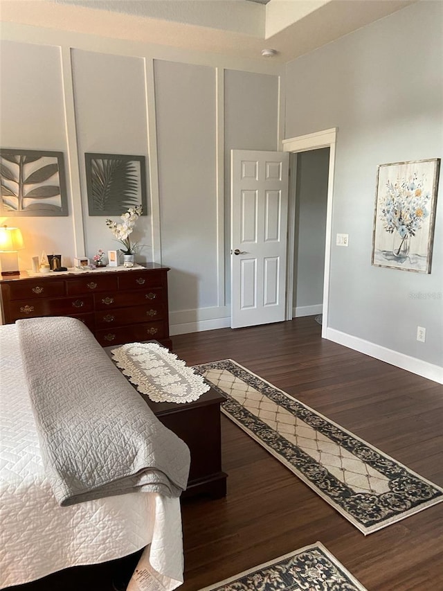 bedroom with dark wood-type flooring