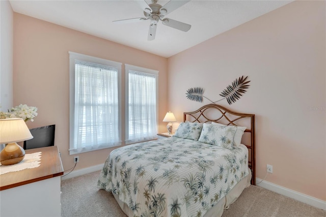 carpeted bedroom featuring ceiling fan and multiple windows