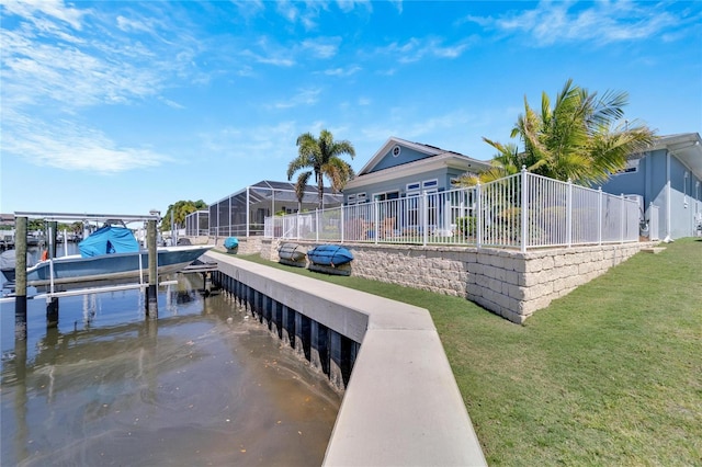 view of dock featuring glass enclosure, a lawn, and a water view