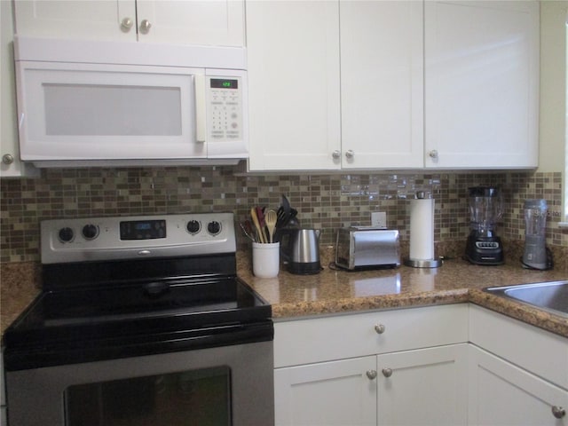 kitchen featuring white cabinets, tasteful backsplash, and stainless steel range with electric stovetop