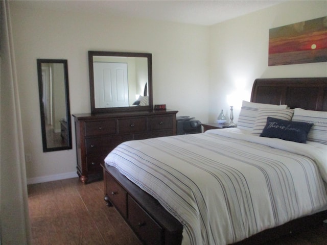 bedroom with dark wood-type flooring