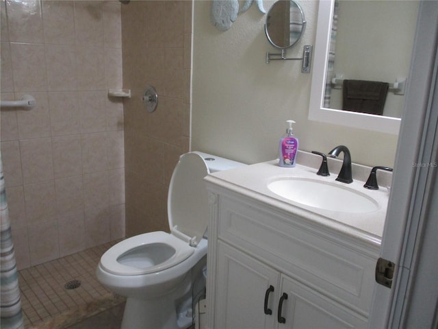 bathroom featuring toilet, a shower with curtain, vanity, and tile patterned floors