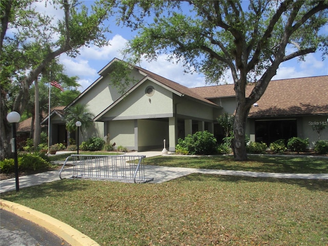 ranch-style house with a front lawn