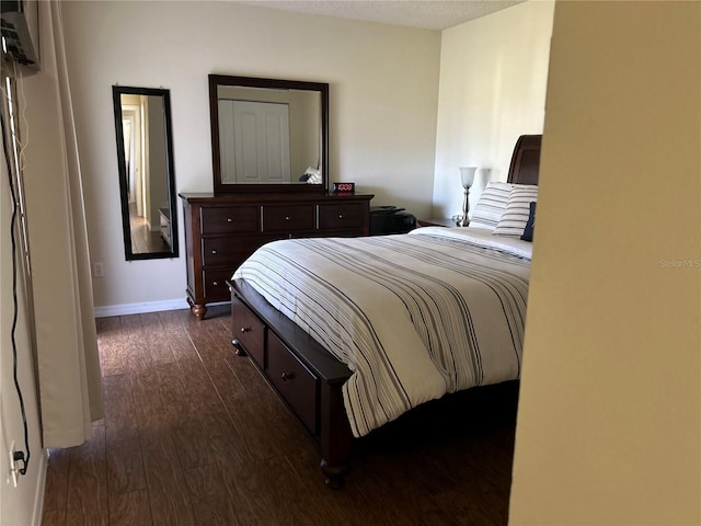 bedroom featuring dark wood-type flooring and a textured ceiling