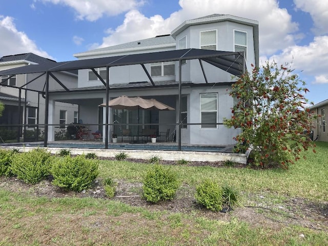 back of house with a patio area and a lanai