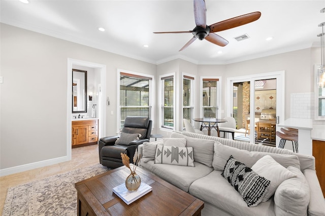 living room with ceiling fan, light tile patterned floors, and crown molding