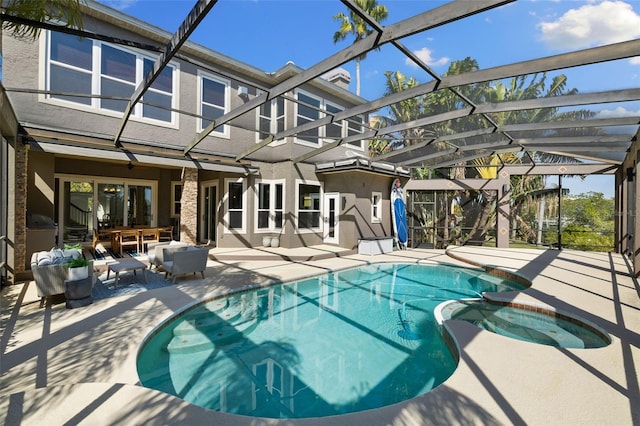 view of swimming pool featuring glass enclosure, ceiling fan, and a patio