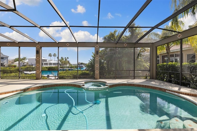 view of pool with a lanai and an in ground hot tub