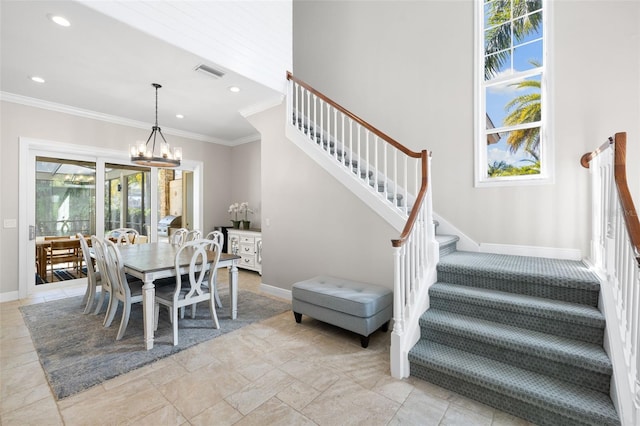 dining room with crown molding and a chandelier