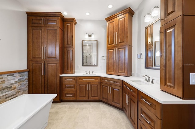 bathroom featuring vanity, tile patterned floors, and a tub