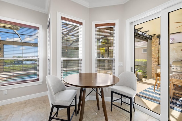 tiled dining space featuring ornamental molding