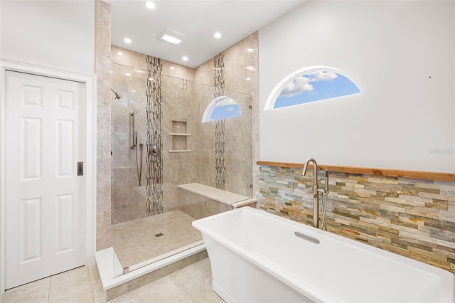 bathroom featuring tile patterned floors and shower with separate bathtub