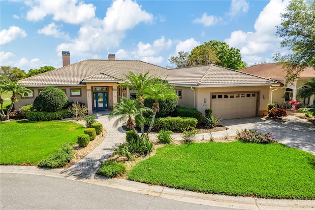 view of front of house with a front lawn and a garage