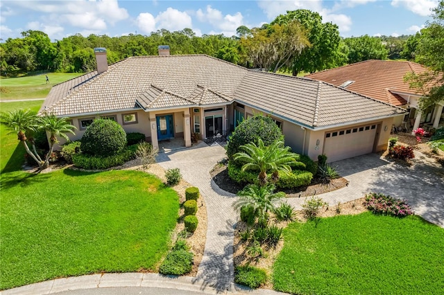 view of front of house with a front lawn and a garage