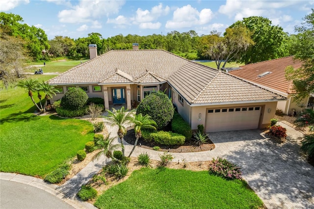 mediterranean / spanish home with a front yard and a garage