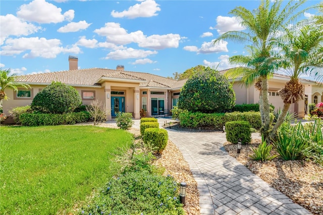 mediterranean / spanish house with a front yard