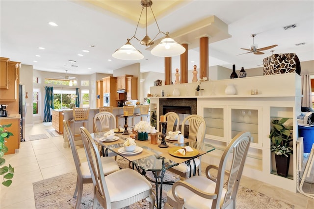 tiled dining area featuring ceiling fan