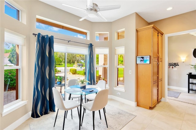 dining space featuring light tile floors and ceiling fan