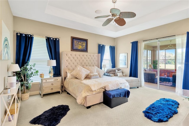 bedroom featuring light carpet, ceiling fan, access to outside, and multiple windows