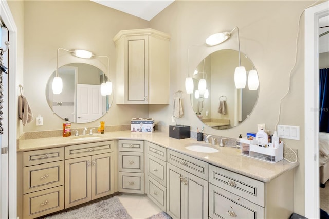 bathroom featuring vanity with extensive cabinet space, tile flooring, and double sink