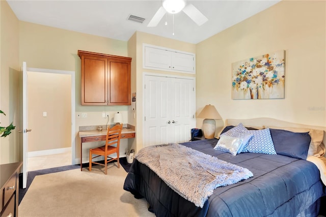 carpeted bedroom featuring a closet and ceiling fan