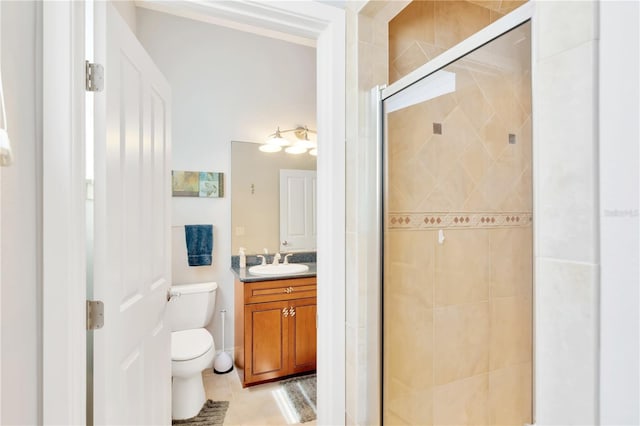 bathroom with a shower with door, tile flooring, large vanity, and toilet