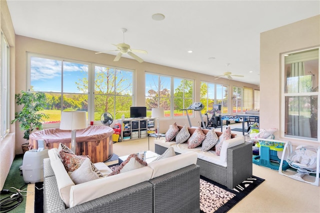 sunroom featuring ceiling fan