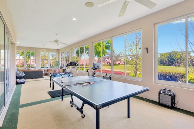 playroom featuring light colored carpet, a healthy amount of sunlight, and ceiling fan