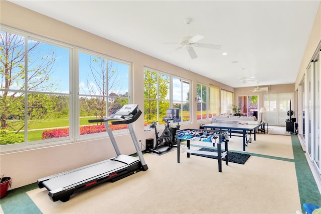 workout room featuring ceiling fan and light colored carpet