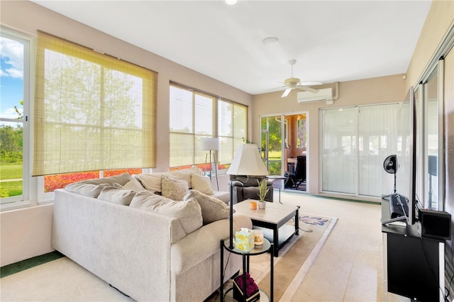 sunroom featuring a healthy amount of sunlight, ceiling fan, and a wall unit AC