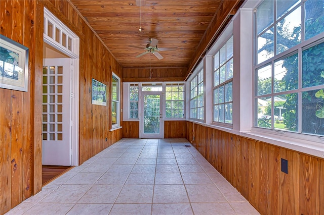 unfurnished sunroom with wood ceiling and ceiling fan