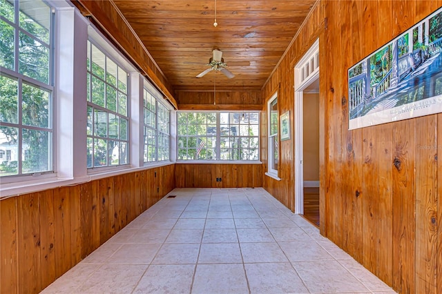 unfurnished sunroom with ceiling fan and wood ceiling