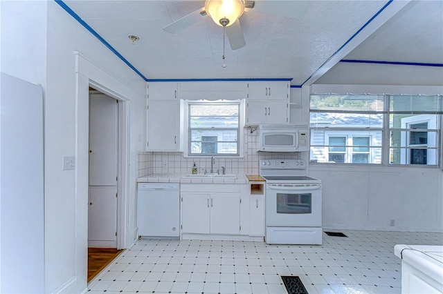 kitchen with tile counters, sink, white cabinetry, white appliances, and ceiling fan