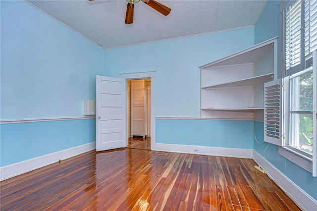 spare room with ceiling fan, ornamental molding, and dark hardwood / wood-style flooring