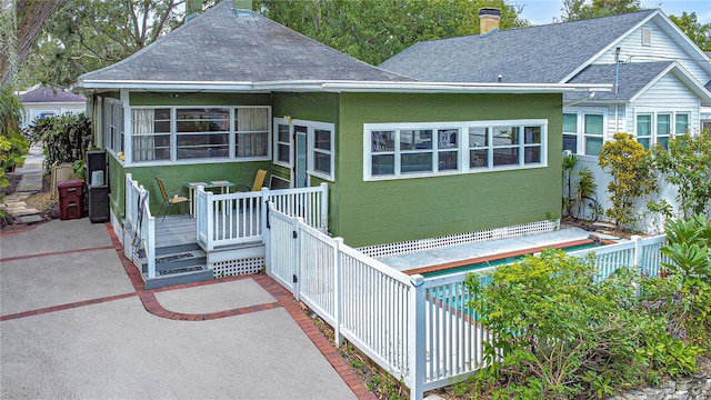 back of property with a patio, a sunroom, and a wooden deck