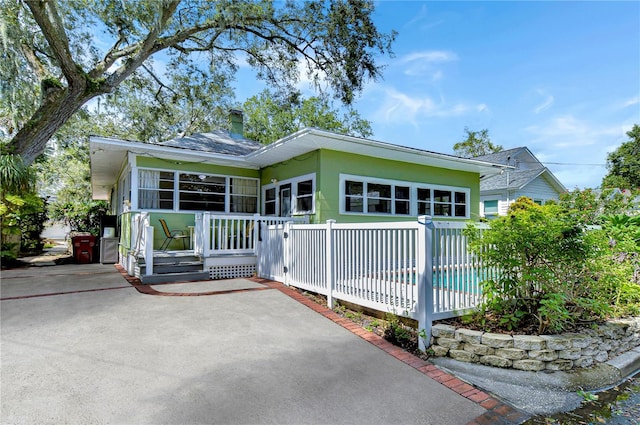 back of property with a sunroom