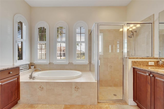 bathroom with independent shower and bath, tile flooring, and vanity