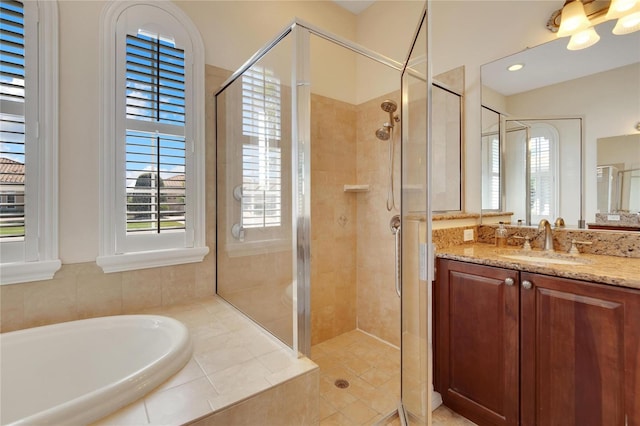 bathroom featuring vanity with extensive cabinet space and plus walk in shower