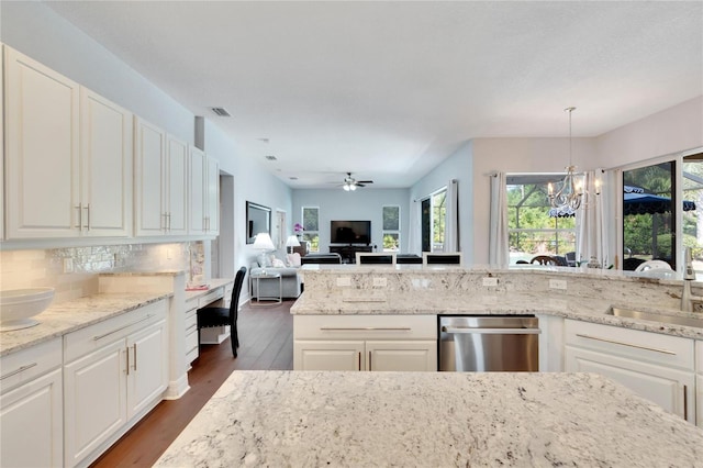 kitchen with stainless steel dishwasher, decorative light fixtures, ceiling fan with notable chandelier, dark hardwood / wood-style flooring, and light stone counters