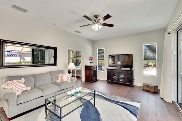 living room featuring ceiling fan and dark hardwood / wood-style flooring