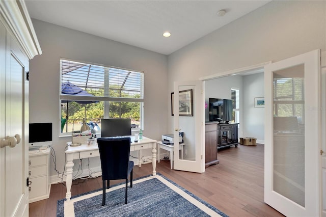 home office with french doors and dark wood-type flooring