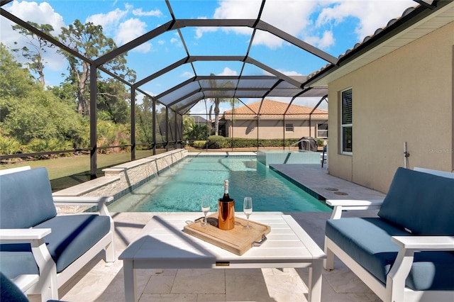 view of swimming pool featuring a patio and a lanai