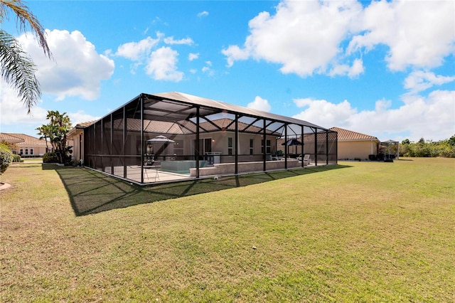 exterior space featuring glass enclosure, a swimming pool, a lawn, and a patio area