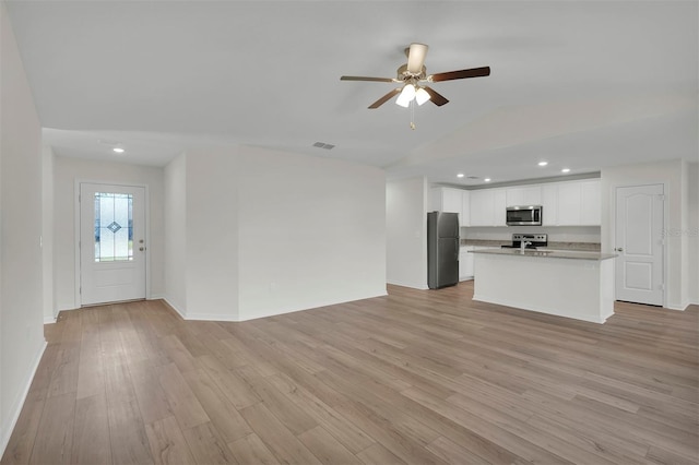 unfurnished living room with light hardwood / wood-style floors, ceiling fan, and vaulted ceiling