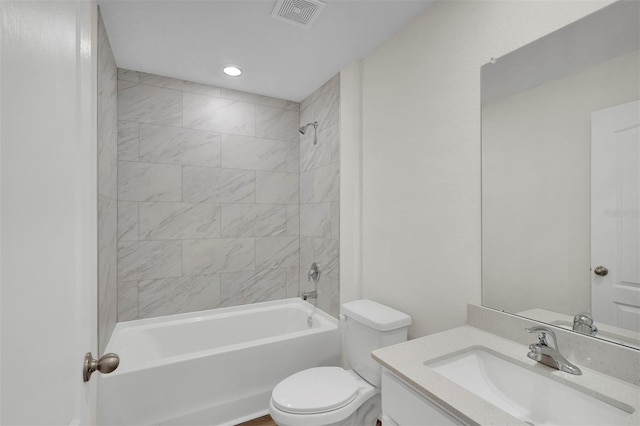 full bathroom featuring vanity, toilet, and tiled shower / bath